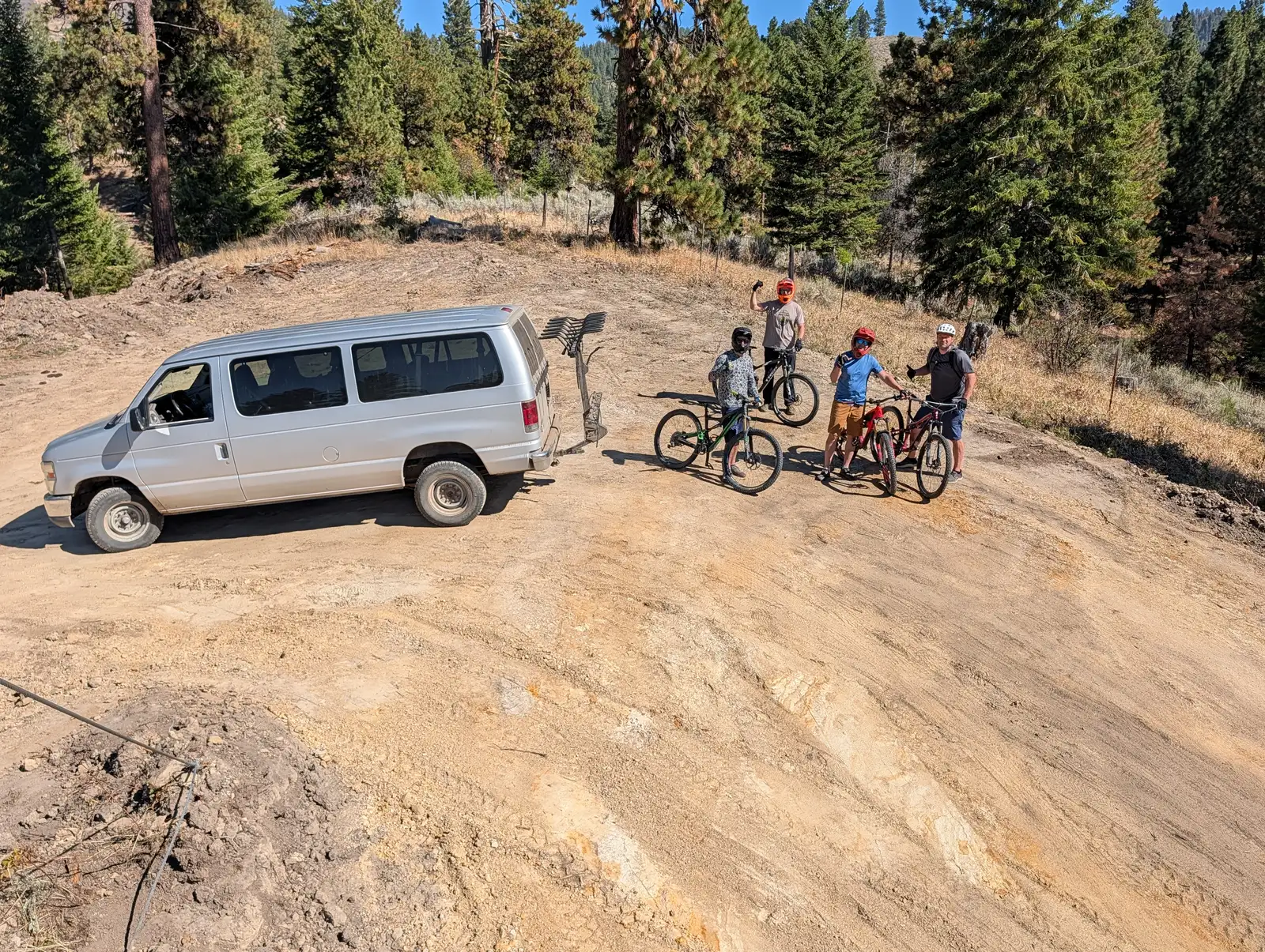 Riders and the shuttle van at the top of the trail at Faull Line Gravity Park in Horseshoe Bend, Idaho